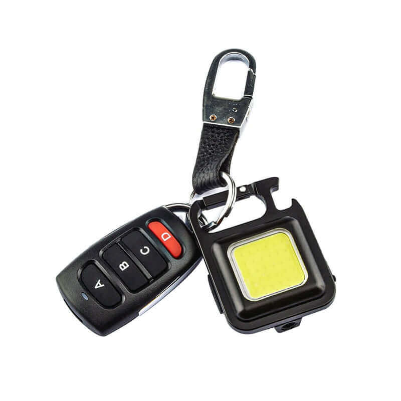 Mini waterproof pocket torch LED keychain flashlight with USB charging and COB LED for versatile lighting, shown attached to car keys.